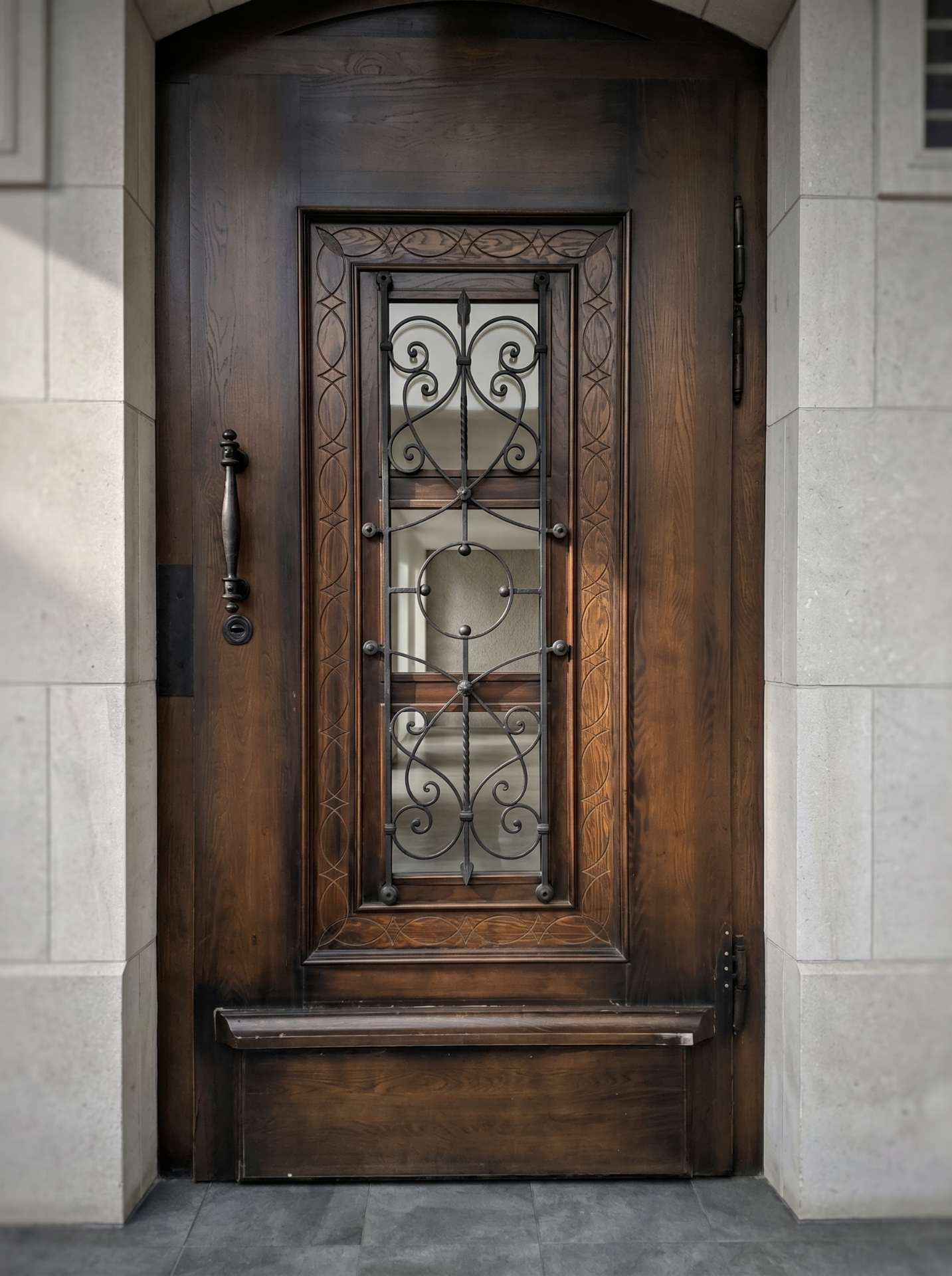 Carved oak door with a wrought iron grille