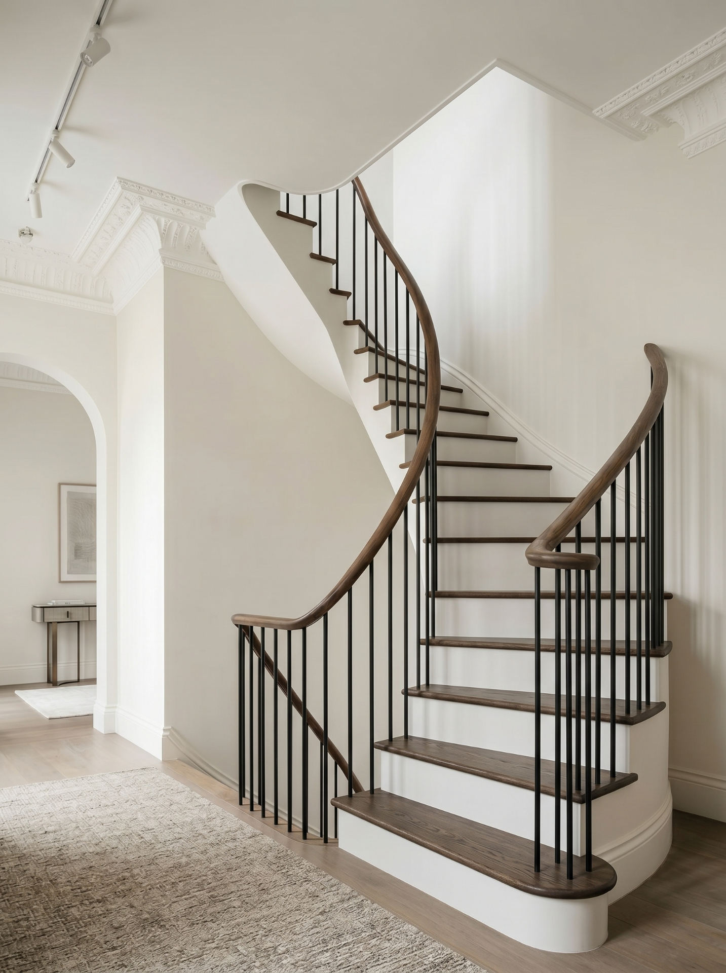 Curved oak staircase with turned metal spindles